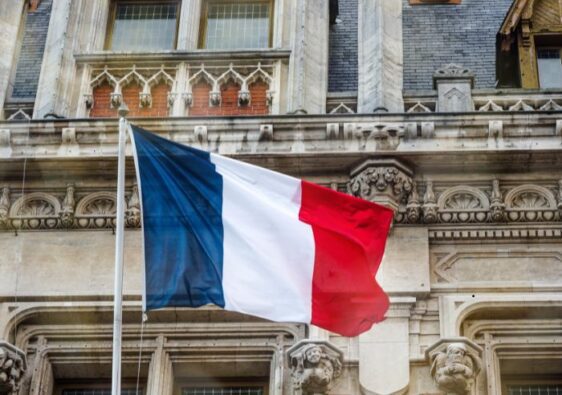 french flag in front of old building